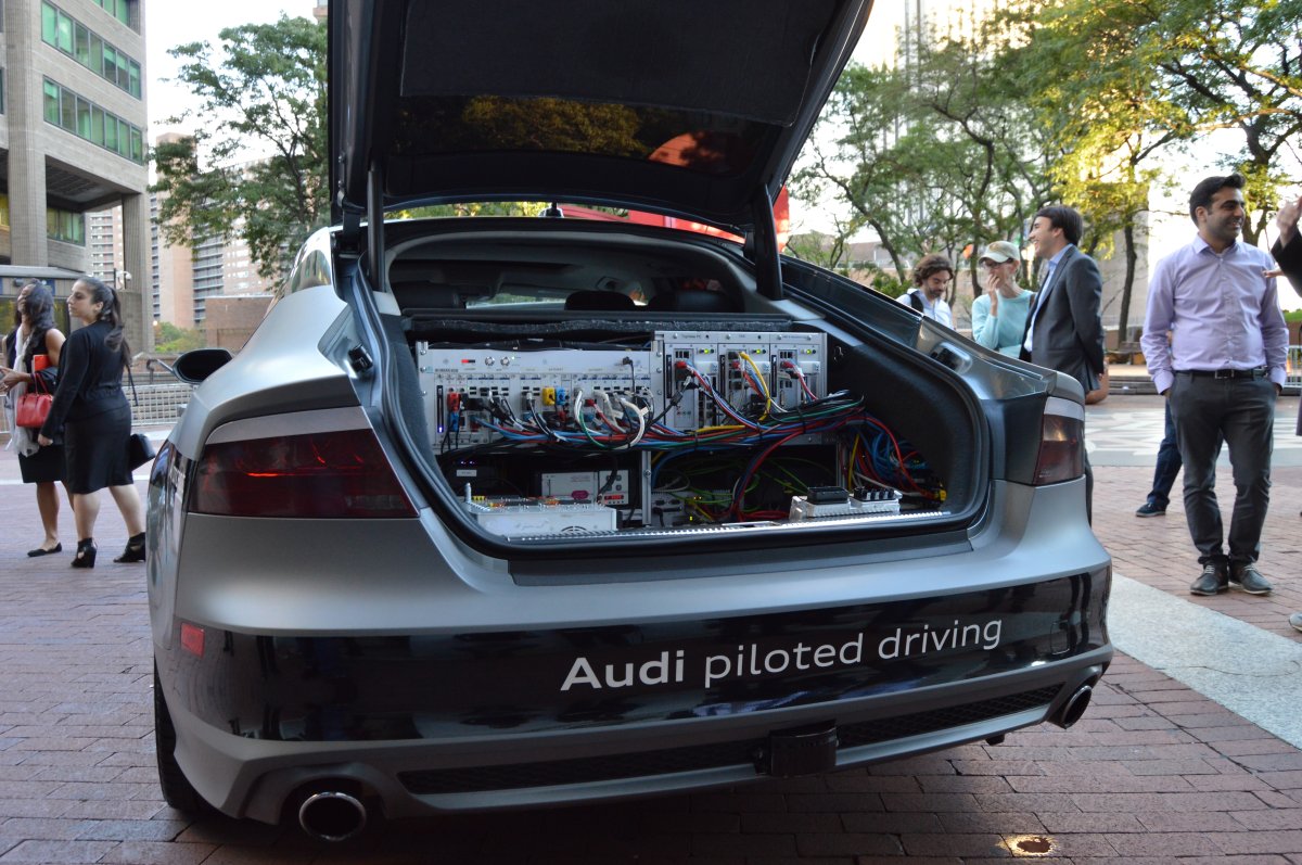 Audi’s A7 driverless prototype parked outside the Municipal Building during Borough President Gale Brewer’s panel discussion on autonomously driving vehicles. The car’s “brain,” looking like some clunky old stereo equipment from the 1970s, is in the trunk. But with new technology, this hardware is soon set to get much smaller.  Photo by Jackson Chen
