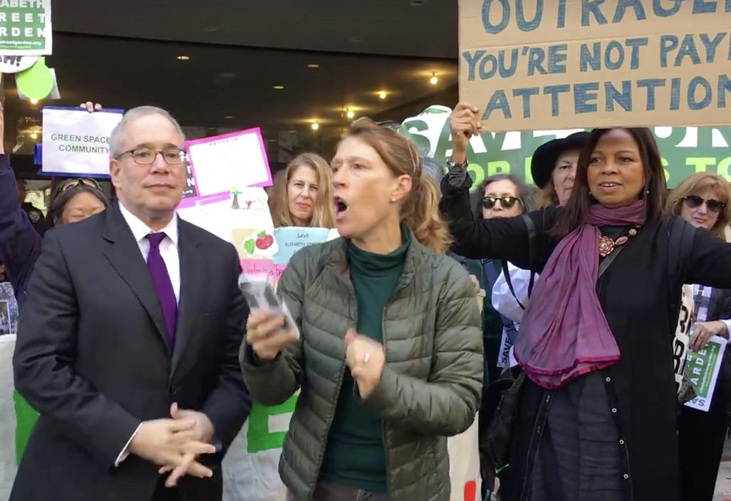 Emily Hellstrom, a leader of Friends of Elizabeth St. Garden, was fired up at Thursday's protest outside the offices of the Department of Housing Preservation and Development. She led the 100-strong crowd in a chant of "We won't be ignored!" City Comptroller Scott Stringer, left, and local politicians supported the gardeners in their call for saving the full garden. Photo courtesy Felicia Young