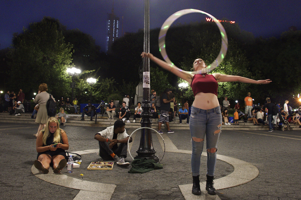 Kaylyn, from Pennsylvania, recently celebrated her 22nd birthday in Union Square with a light-up hula hoop.  Photo by Bob Krasner 