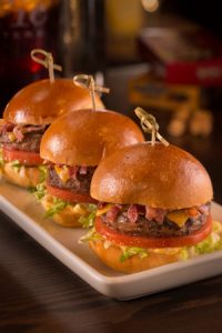 Photo by Eduardo Chacon / iPic Theaters This trio of angus sliders is topped with something called "candied espelette bacon" — sound delicious, whatever it is.
