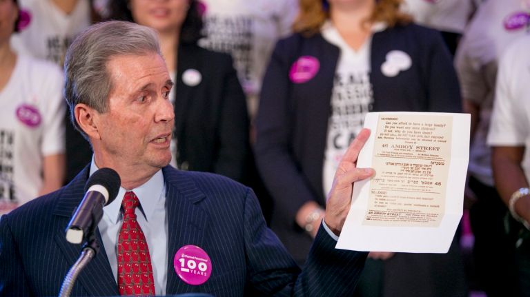 Alexander Sanger holds up a copy of a flyer printed by his grandmother Margaret Sanger at a ceremony at City Hall in Manhattan celebrating the 100th anniversary of the founding of Planned Parenthood, on Sunday, Oct. 16, 2016.