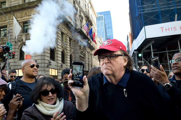 Trump Tower: #NotMyPresident Ground Zero 7 Filmmaker and activist Michael Moore, here filming with his phone, was among Saturday's demonstrators. | DONNA ACETO