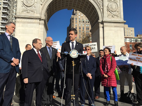 Flanked by colleagues, State Sen. Brad Hoylman speaks out about hate crimes after a woman in his building discovered a swastika carved into a door there. Photo courtesy Office of State Sen. Brad Hoylman.