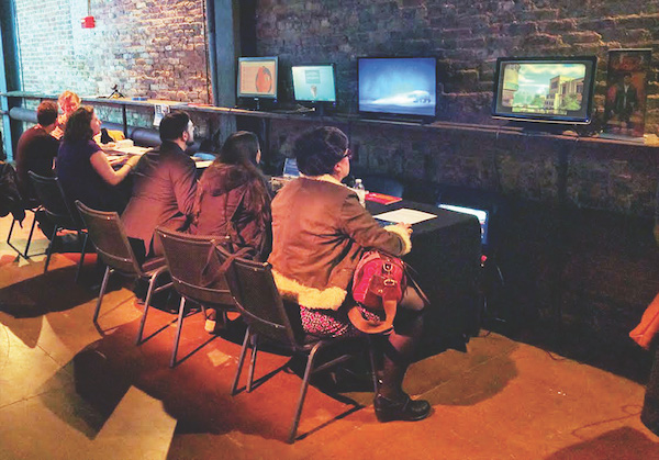 A group engaged in the Games for Change section. Photo by Davis Cox.