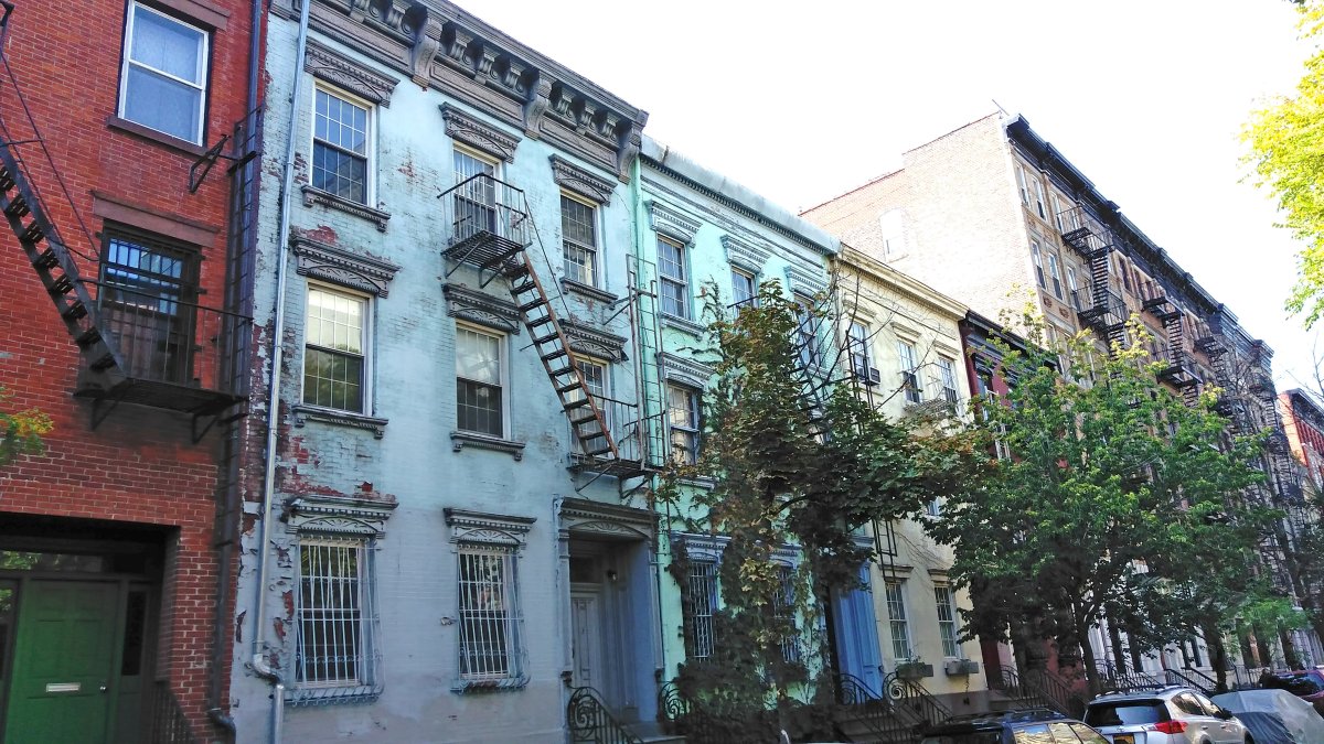 The owner of 264 E. Seventh St., the blue building second from left, next to the red-brick building, has filed a permit to demolish the entire structure. Photo by Dennis Lynch