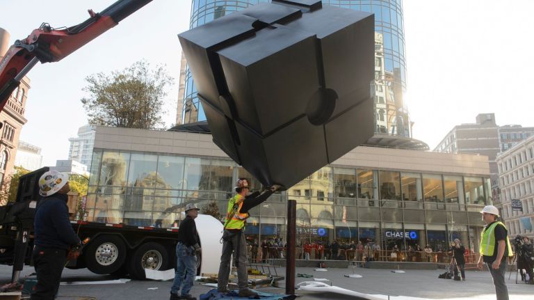 Workers install the Alamo Cube, better known as the Astor Place cube, on Tuesday, Nov. 1, 2016. The cube was removed in 2014 while the public space was being renovated.