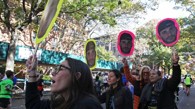 Spectators cheer on their loved ones during the TCS New York City Marathon on Sunday, Nov. 6, 2016.
