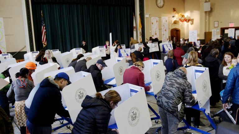 Voters cast their ballots at St. Sebastian's School in Woodside, Queens, Tuesday, Nov. 8, 2016.