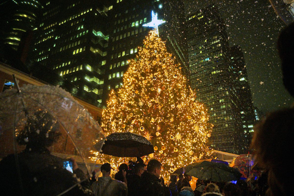 Photo by Milo Hess The damp weather couldn't put a damper on the festive mood at the South Street Seaport Tuesday night for the 33rd-annual tree-lighting ceremony.