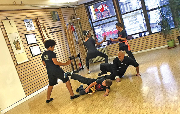 Working on floor kicks with intermediate students. Photo courtesy NSKF.