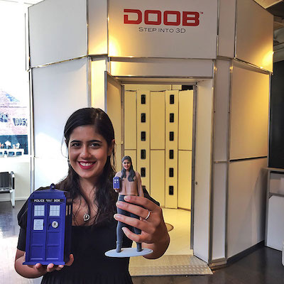 A woman poses with a miniature version of herself, courtesy DOOB 3D printing. Image via doob3d.com.