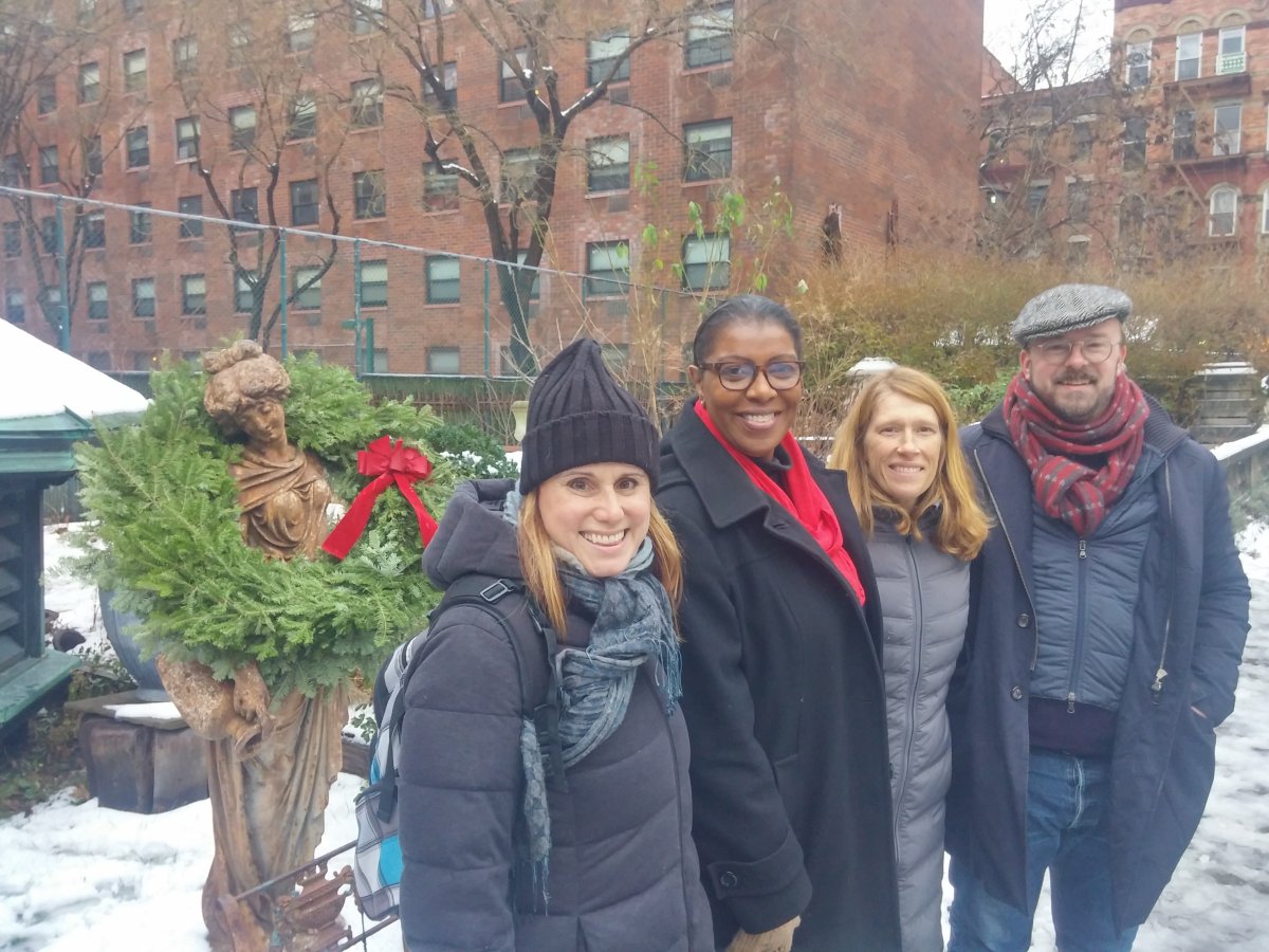 Public Advocate Letitia James, second from left, joined Friends of Elizabeth St. Garden members, from left, Jeannine Kiely, Emily Hellstrom and Aaron Booher, at the garden's Winter Solstice Celebration last weekend. “Count me in!” James said of the effort to save the green spot in open-space-starved Little Italy. She’s now the second citwide elected official, along with Comptroller Scott Stringer, to stand with residents and Community Board 2 in their effort to save the treasured garden from the wrecking ball.