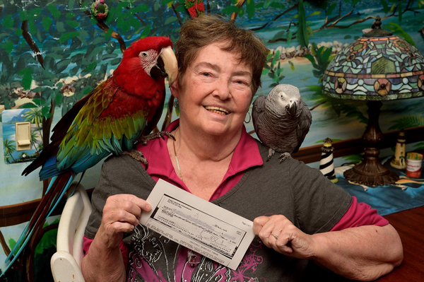 Photo by Donna F. Aceto Gateway resident Nancy Chambers — a.k.a. The Parrot Lady — holds a copy of a rent check she said she mailed on Oct. 1 along with several other bill payments, but it wasn’t deposited until Oct. 12, nearly a week after all the other checks had cleared. So she’s crying fowl over the late fee she was charged.