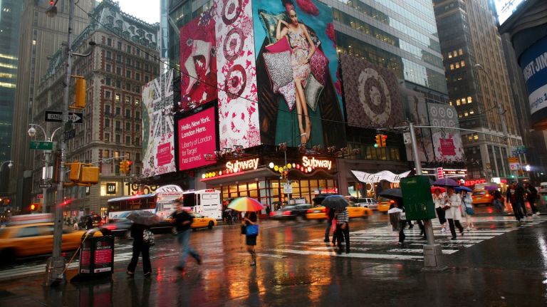 Pedestrians walk past the corner of 42nd Street and 7th Avenue in Times Square May 3, 2010 in New York City.