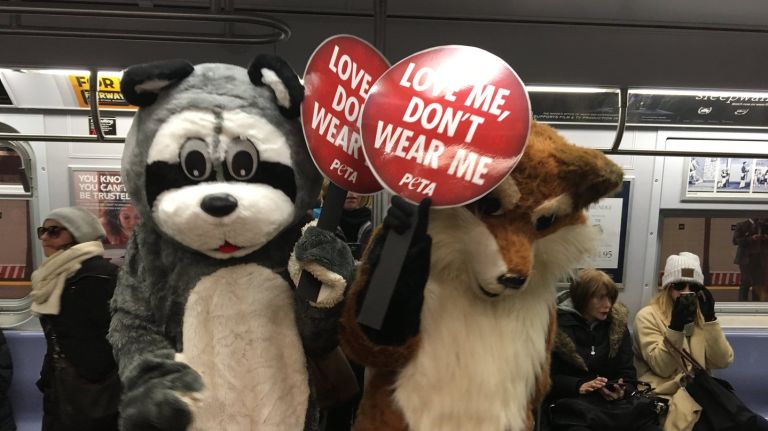 PETA protests fur fashion in Herald Square, Q train, SoHo 2 PETA protesters dressed in animal costumes took to the subway to urge holiday shoppers not to purchase fur products.