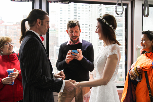 High Over East River, Among Strangers, Couple Make Vows 4 The Most Reverend Matt Levy officiated Wesley Hansen and Jennifer Dreussi Hansen’s wedding on board the Roosevelt Island Tram. | JENNY MACFARLANE/ STYLISHHIPWEDDINGS.COM