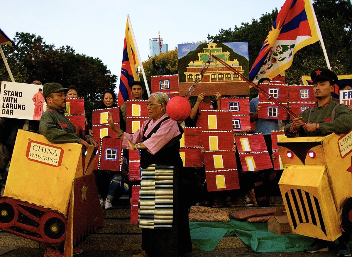 During the protest for Larung Gar last month in Union Square, activists portraying Chinese demolition machines symbolically threatened to destroy the Buddhist enclave as a senior woman pleaded with them to stop. Photo by Jane Stein