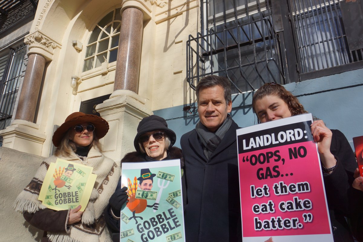 State Senator Brad Hoylman with tenants of 325 E. 12th St. at a protest outside the building two days before Thanksgiving. The tenement has been without cooking gas for half a year. The tenants waved frozen turkey dinners to help drive home the message. Photo by Sarah Ferguson