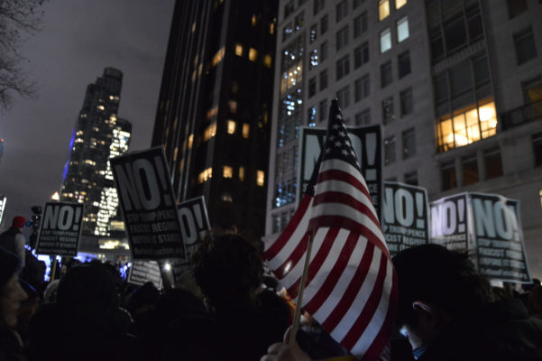 Defiant signs of No! mixed with American flags. | JACKSON CHEN