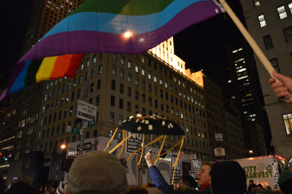 Tens of Thousands Gather in Resistance on Inauguration Eve 2 The LGBTQ Rainbow Flag was also raised at the rally. | JACKSON CHEN