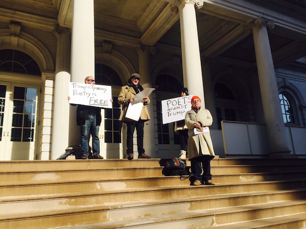 Event organizer Alan Kaufman (center) opened with his poem “Let Us.” Photo by Puma Perl.