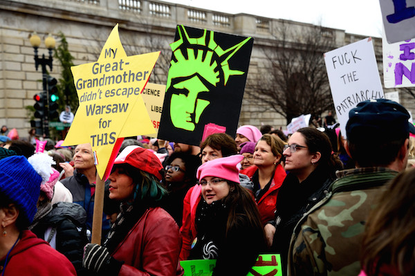 Women Marched on Washington, with the World in Lock Step 11 Signs, such as this reminder of Warsaw, warned of the dark path the nation cold take under President Trump. Photo by Donna Aceto.