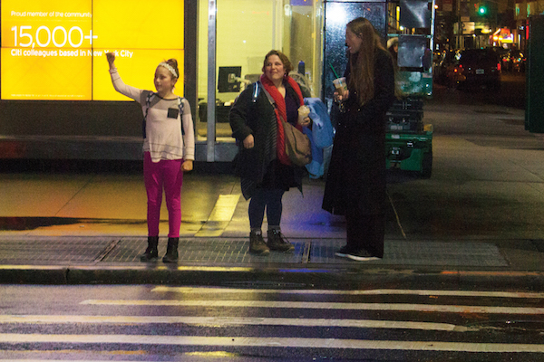 Activists Promise Grassroots Movement to Fight Trump 4 A girl expressed her solidarity with marchers as they marched Downtown to a Trump property located at 40 Wall St. Photo by Zach Williams.