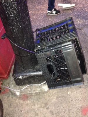 The Community Council is working on the removal of derelict bikes and “street furniture,” such as these milk crates tied to a lamppost. Photo by John A. Mudd.