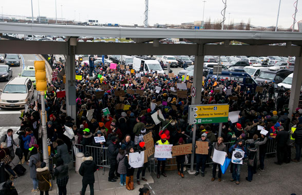 Ban on the Run: Protests at JFK, Jubilation at Brooklyn Courthouse 1 People protest outside of Terminal 4 at JFK. Photo by Julius Constantine Motal.