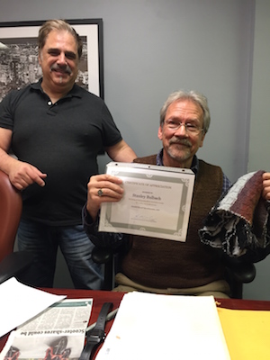 Bully for Bulbach: Block Association Honors Outgoing Leader 1 Stanley Bulbach, seated, shows the certificate given for his tenure as head of the West 15th Street 100 and 200 Block Association. Also pictured is Kimon Retzos of the block association. Photo courtesy Steve Starosta.