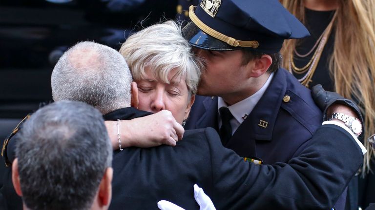 Patricia McDonald, center, wife of NYPD Det. Steven McDonald, and her son Conor, right, are greeted by former Police Commissioner Ray Kelly, following a funeral mass for McDonald at St. Patrick's Cathedral on Friday, Jan. 13, 2017.