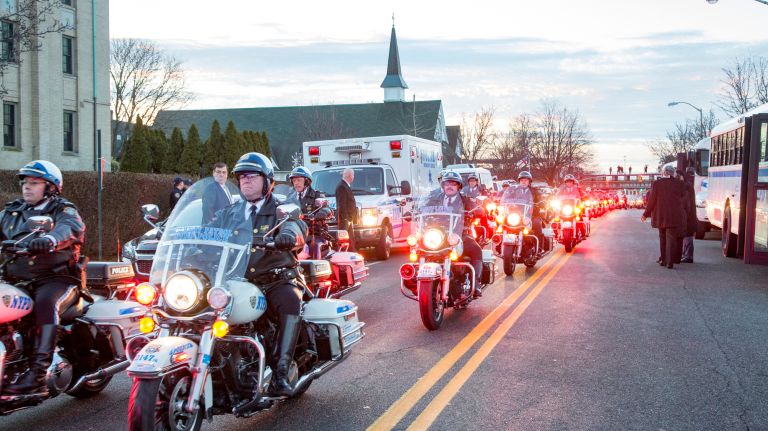 Police escort leads the hearse carrying the coffin of Det. Steven McDonald on Friday, Jan. 13, 2017 in Rockville Centre.