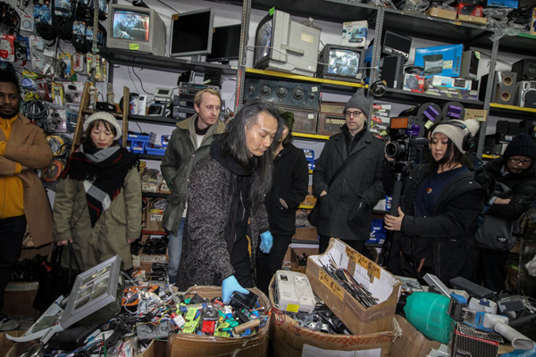 Photo by Tequila Minsky Musician Aki Onda, center, picks out materials for his opening night improvised performance at Argo Electronics on Jan. 5, while Motoko Fukuyama, at right, films the process for her art project called “You Never Know What Idea You Might Have” — which is also the store’s slogan.