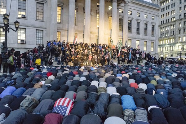 Yemeni deli workers offer a prayer at the start of a February 2 rally at Brooklyn Borough Hall. | STEFANO GIOVANNINI 