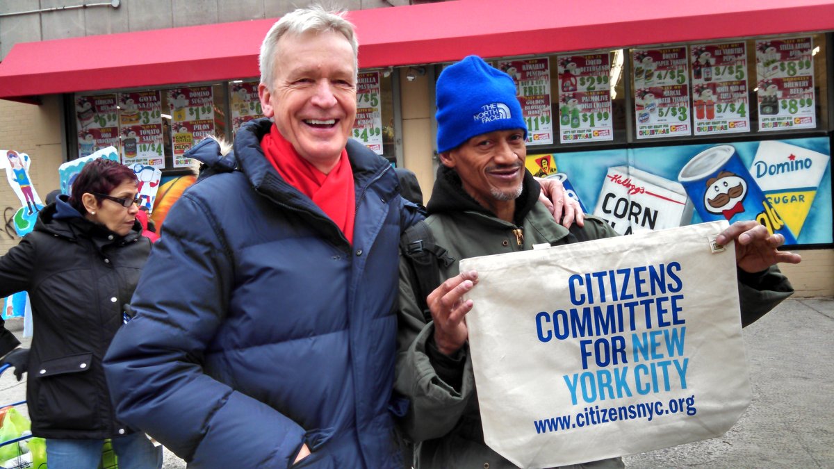 In December 2014, Peter Kostmayer, C.E.O. of Citizens Committee of New York City, left, joined local school kids in distributing free canvas tote bags outside a supermarket on Avenue C. Citizens Committee has been one of the biggest boosters of the city’s bill to impose a small surcharge on plastic bags at local markets. Villager file photo