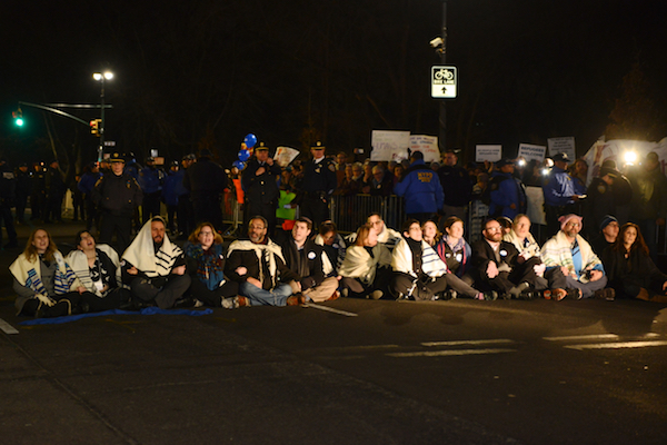 Nineteen rabbis affiliated with the Jewish social justice group T’ruah staged a sit-in on Central Park West outside the Trump International Hotel on February 6. Later, the group tweeted, “This is what Judaism looks like. | GILI GETZ