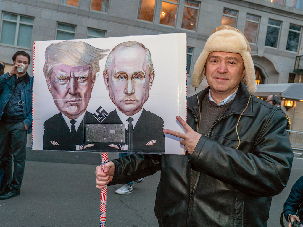 Moore, de Blasio and celebs call for ‘100 days of resistance’ 11 "You're Putin me on...": A demonstrator's sign at the start of the rally.