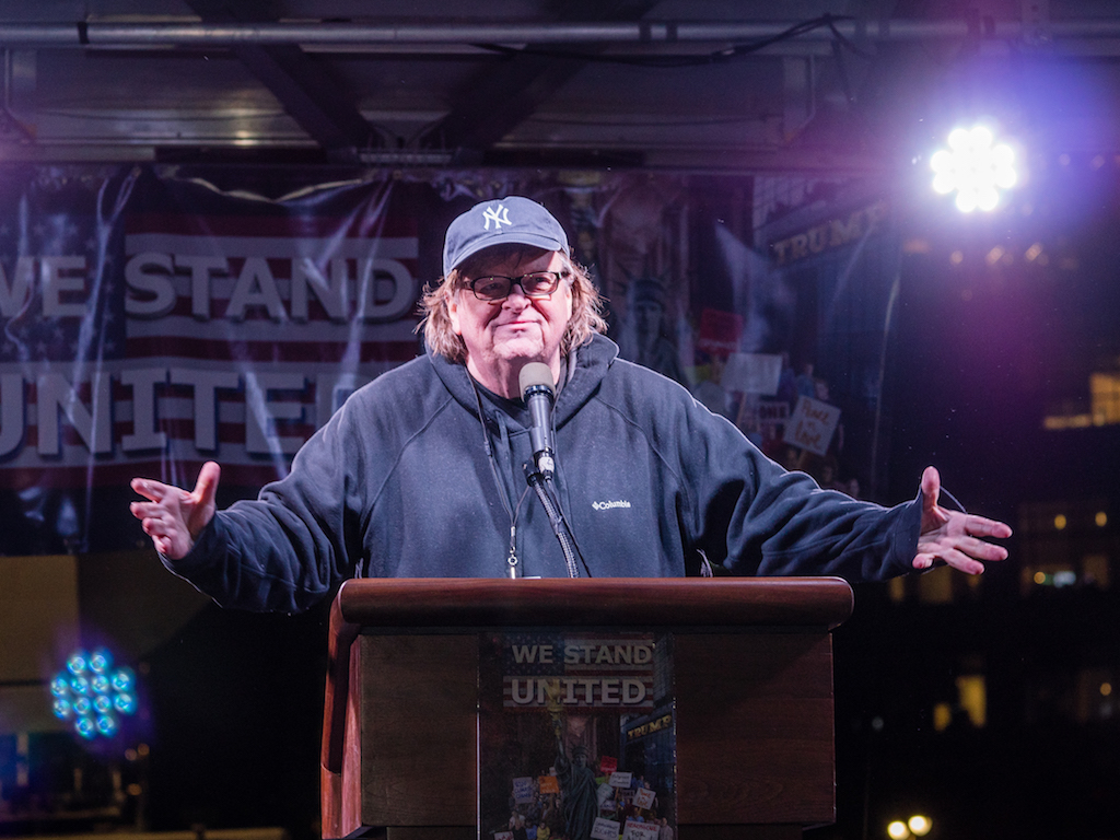 Michael Moore urged the thousands in the crowd to wage a 100-day campaign of resistance against the new president.
