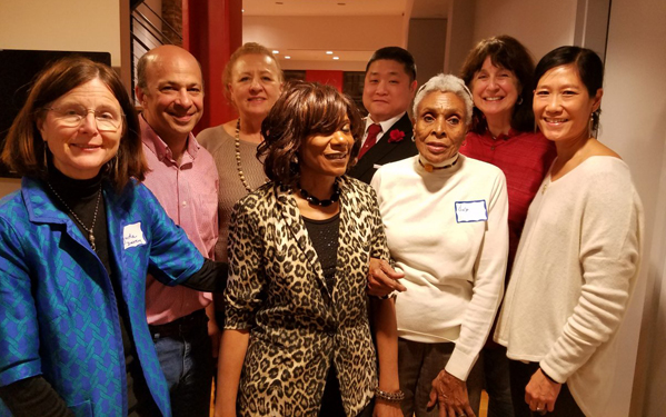 Photo By Janel Bladow Members of the Brooklyn Bridge South Neighborhood Association — including, left to right, hosts Lynda Davey and Alan Schiffres, treasurer Linda Roche, member Loretta White, spokesman Bryan Jung, president Una Perkins, secretary Zette Emmons, and member Vera Sung (member) — braved the snow on Saturday to meet up and reconnect.