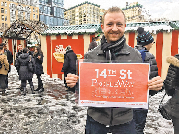 A volunteer for Transportation Alternatives this past winter advocating at Union Square for his group’s “PeopleWay” plan for 14 St. during the coming L train shutdown in Manhattan. The writer claims that during recent community workshops at which the issue was discussed, TransAlt “seeded” tables with its members, who selectively jotted down suggestions that jibed with the plan. Photo courtesy The Villager.