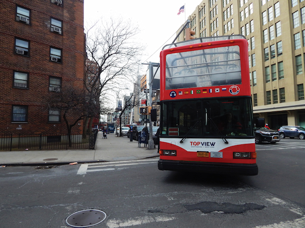 Turn Restriction Shifts Tour Buses to Side Streets 1 A “hop-on, hop-off” tour bus turns from 10th Ave. onto W. 26th St. to make a northbound turn onto Eighth Ave. Photo by Dennis Lynch.