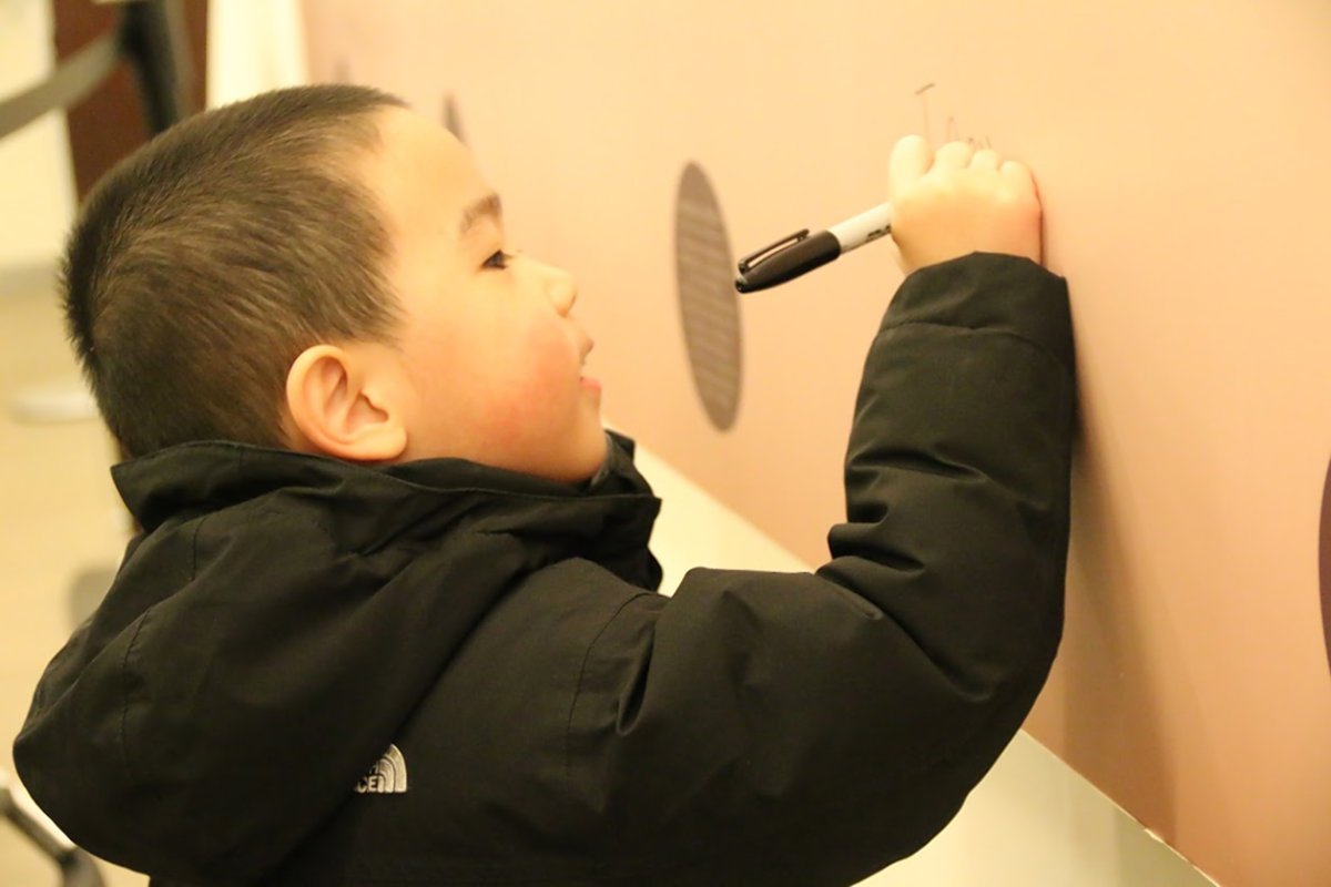 A young boy signed his John Hancock under the “We the People” mural at the Educational Alliance. Photos courtesy of Educational Alliance