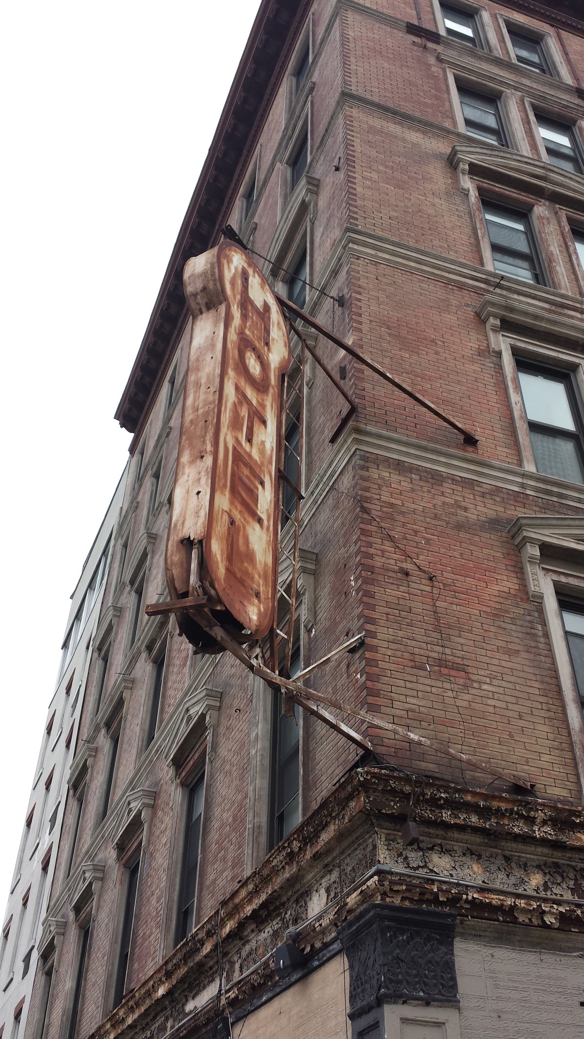 The Keller Hotel was rundown and empty for years. “Even when it had a leather bar, the block was quiet,” a neighbor said, testifying against the new plan for the old hotel at the C.B. 2 meeting last week. Photo by Lincoln Anderson