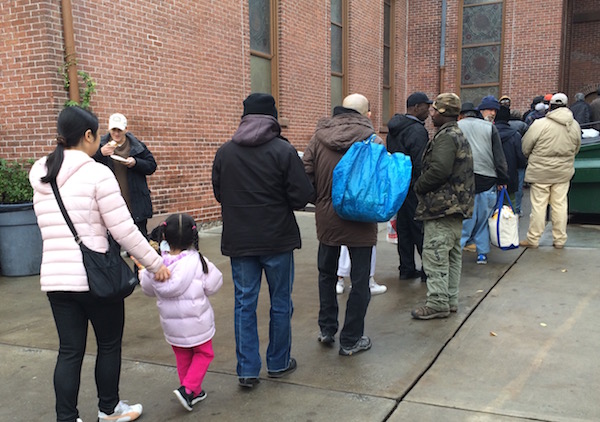 A line forms for the Holy Apostles Soup Kitchen, which serves 300,000 meals a year. Photo by Hannah Albee.