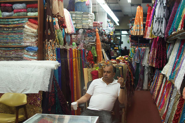Uddin Hasina, owner of Ayazmoon Fabric, has run his business out of 214B W. 39th St. for 25 years. Photo by Jackson Chen.