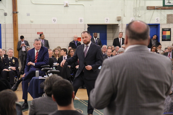 Mayor de Blasio and Councilmember Corey Johnson listen as Fulton Houses Tenants’ Association president Miguel Acevedo asks about a lack of M/WBE (minority and women-owned business enterprises) at Hudson Yards. Photo by Dennis Lynch.