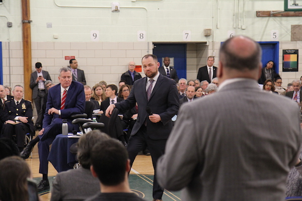 Mayoral Q&A: A Tale of Two Hours at a Town Hall 2 Mayor de Blasio and Councilmember Corey Johnson listen as Fulton Houses Tenants’ Association president Miguel Acevedo asks about a lack of M/WBE (minority and women-owned business enterprises) at Hudson Yards. Photo by Dennis Lynch.