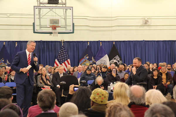 Mayor de Blasio gave former State Senator Tom Duane (seated in front of the American flag) a nod at the beginning of the town hall. Photo by Dennis Lynch.