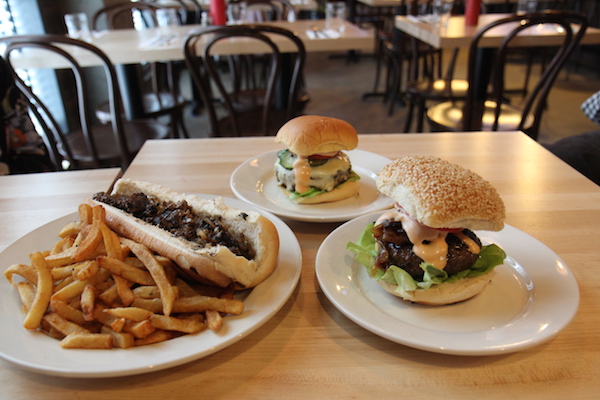 Burger Joint Puts Meat on the Bones of an Emerging Neighborhood 1 L to R: The East Villi Cheese Steak, Whitmans’ classic cheeseburger, and the unrivaled Juicy Lucy. Photo by Dennis Lynch.