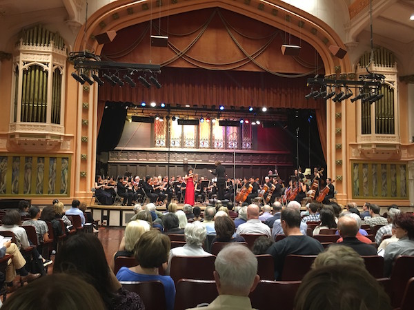 Guest soloist Adele Anthony, in red, at the Greenwich Village Orchestra’s season opener. Their next concert is March 19. Photo by Aled Roberts.